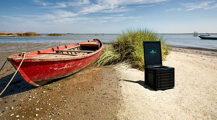 TROBOLO BilaBox mobile toilet on a beach next to a boat