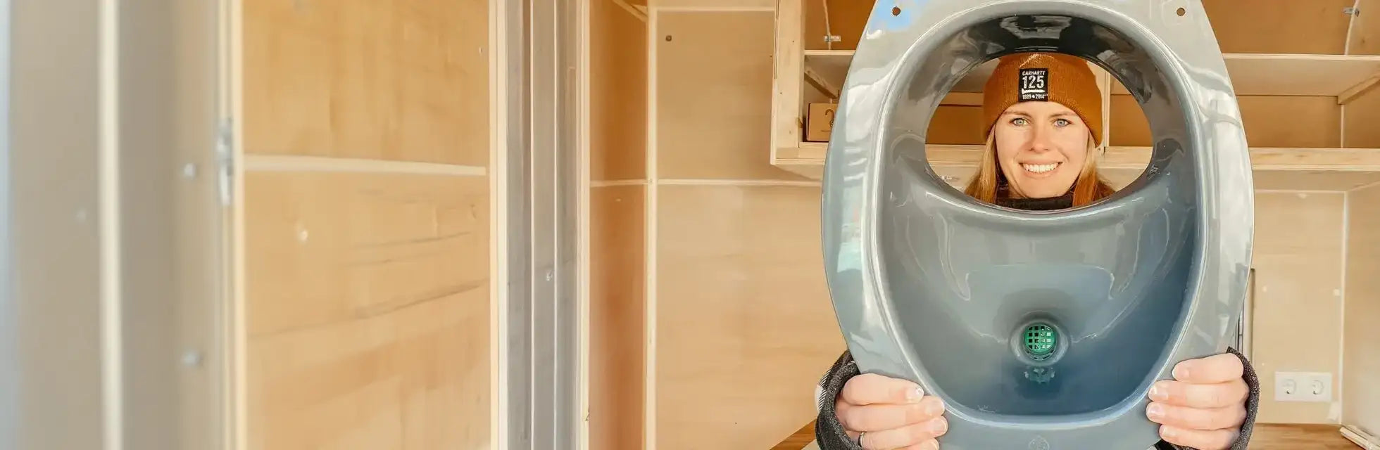 Woman holding composting toilet