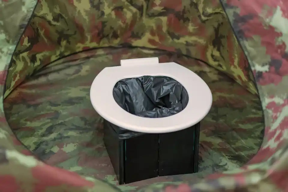 Small bucket toilet as camping toilet placed in toilet tent