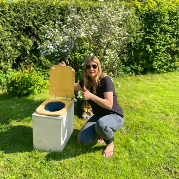 TROBOLO TeraBloem composting toilet in garden next to woman