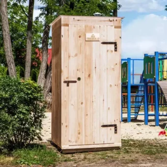 Composting toilet TROBOLO KersaBoem outside in front of a playground
